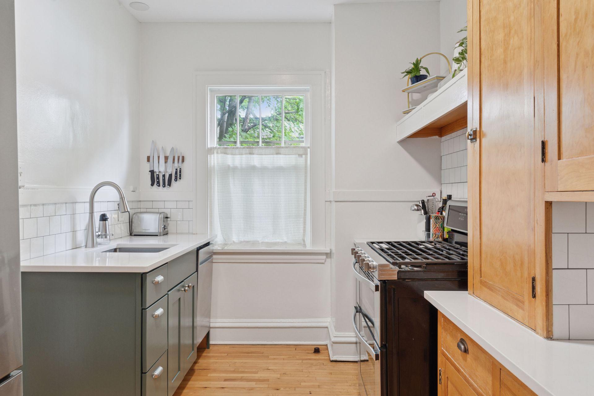 Stainless steel appliances and quartz countertops - window faces North.