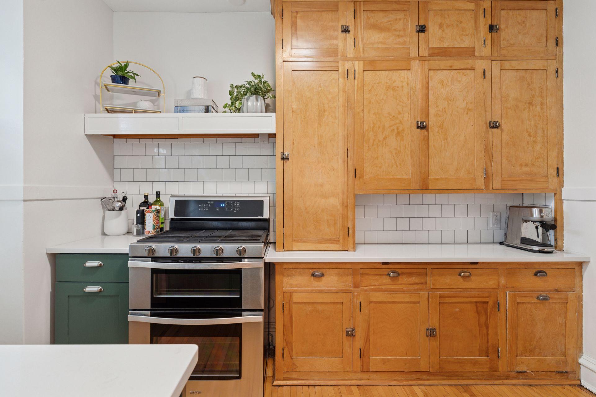 The kitchen is a perfect blend of painted and vintage cabinetry. Double oven range is an asset for cooking and baking.