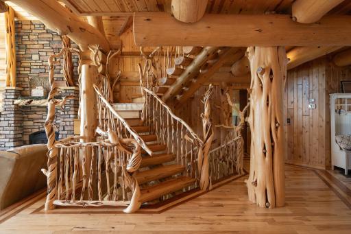 This grand entry featuring spiral staircase and hand scribed railings