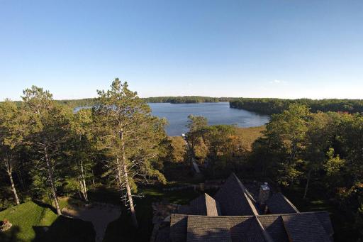 Aerial drone photo from behind the home looking towards the lake