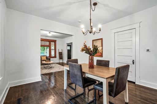 The formal dining room flows effortlessly into the living room and kitchen, creating a cohesive and open layout.