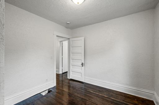 Refinished hardwood floors extend through each bedroom and flow seamlessly down the hallway.