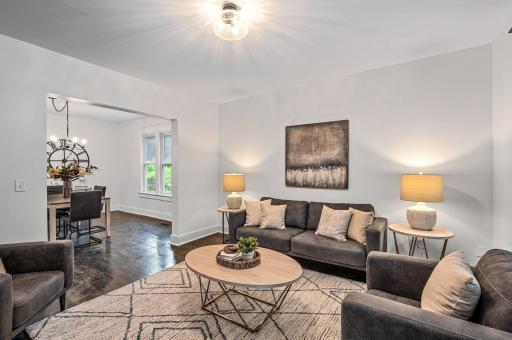 The main level showcases gleaming, refinished original hardwood floors, complemented by neutral paint and an abundance of natural light.