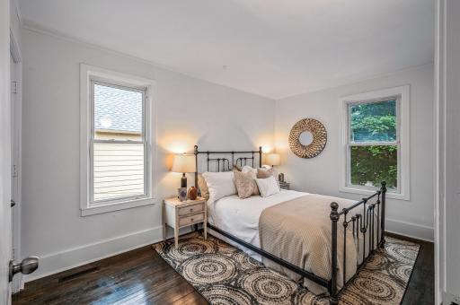The primary bedroom has dual windows allowing abundant natural light to flood the space.