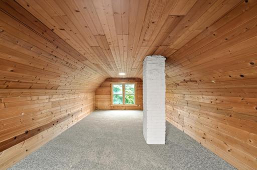 The third level offers a spacious and versatile loft with charming knotty pine.