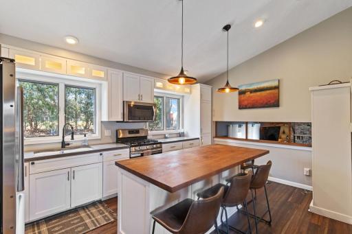 Open concept kitchen with windows overlooking the spacious backyard.