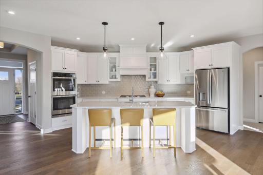 Our gourmet kitchen defines how the WOW comes standard. With a huge center island, granite countertops, gas cook top, and double ovens, plus so much more! (Pic of a previous model)