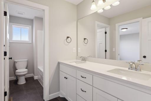 Jack-n-Jill bath on upper level. (Pic of a previous model)