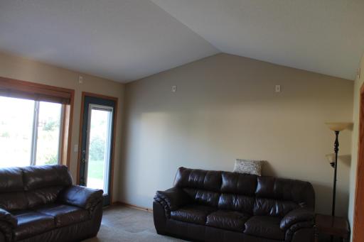 Vaulted ceilings in the living room. Large window lets the sunlight in. Watch the birds/waterfowl in the pond or watch the friendly game of pond hockey in the winter. Patio leads out to a level and inviting concrete space.