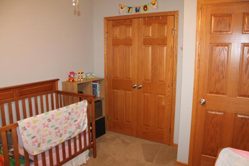 Upstairs 2nd bedroom with 6 panel solid wood closet doors.