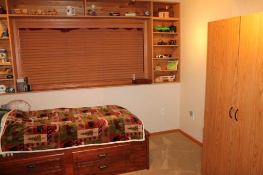 Built-in shelving will be staying with the new owners. The Armoire is also staying. There is no closet in the room.