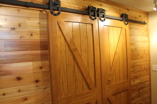 Sliding barn doors with accent lighting. This is absolutely stunning and is a must see!