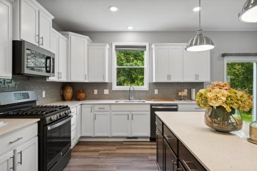 (Photos of model home, finishes will vary) With ample cabinetry storage, everything is kept both within reach and out of sight at the same time.