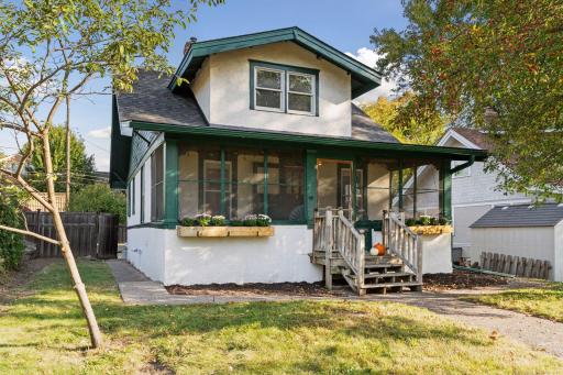 Photo for 1129 Randolph Avenue, Saint Paul, MN 55105 - listing #6744600 Side perspective showcasing the deep lot, fenced yard, and the home’s charming Craftsman details including gabled roofline and wood trim.
