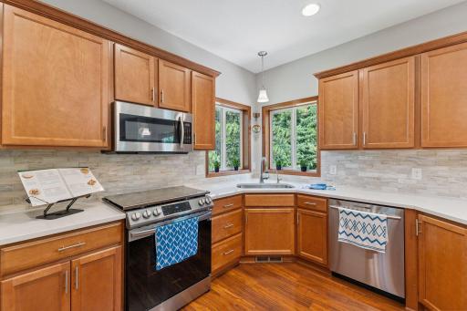 The kitchen window gives a corner view into the nature below.