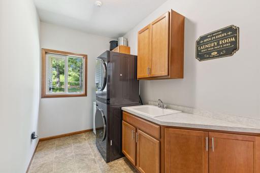 The main floor laundry room has a brand-new washer and dryer, plus plenty of storage space and a window to remind you that even while doing laundry, you live in a beautiful place!
