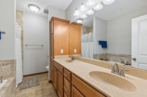 The primary bath has plenty of storage and double sinks.