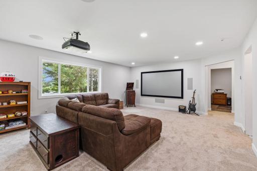 The newly finished (2025) lower level has a built-in theater screen, projector and surround sound. It is the PERFECT place to host the big game!