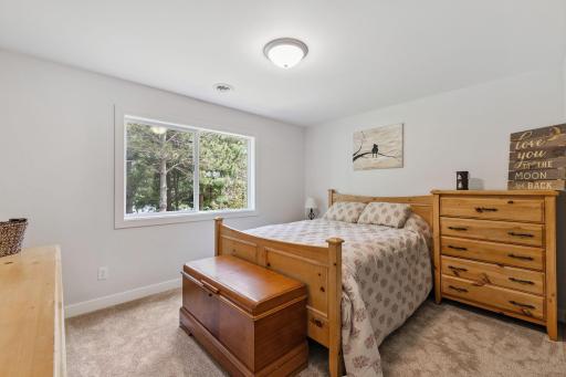 This is third bedroom that is in the lower level with views of the lake and wooded areas.