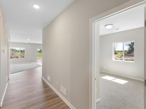 Hall. Photo taken of another home with similar plan and finishes. Photos and renderings may not depict actual plan, materials, & finishes may vary. All measurements are approximate.