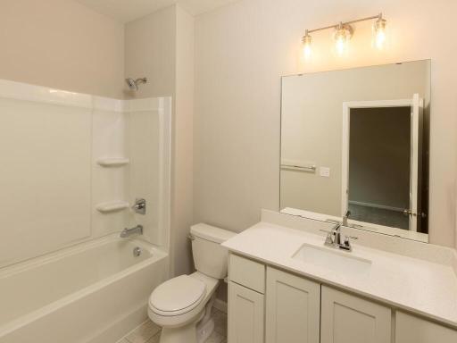Bedroom 2 Private Bathroom Ensuite. Photo taken of another home with similar plan and finishes. Photos and renderings may not depict actual plan, materials, & finishes may vary. All measurements are approximate.