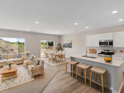 Open Layout, Virtually Staged. Photo taken of another home with similar plan and finishes. Photos and renderings may not depict actual plan, materials, & finishes may vary. All measurements are approximate.
