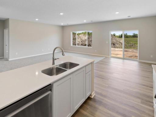 Kitchen. Photo taken of another home with similar plan and finishes. Photos and renderings may not depict actual plan, materials, & finishes may vary. All measurements are approximate.