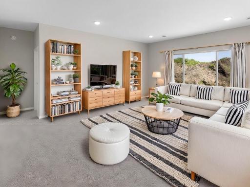 Living Room, Virtually Staged. Photo taken of another home with similar plan and finishes. Photos and renderings may not depict actual plan, materials, & finishes may vary. All measurements are approximate.