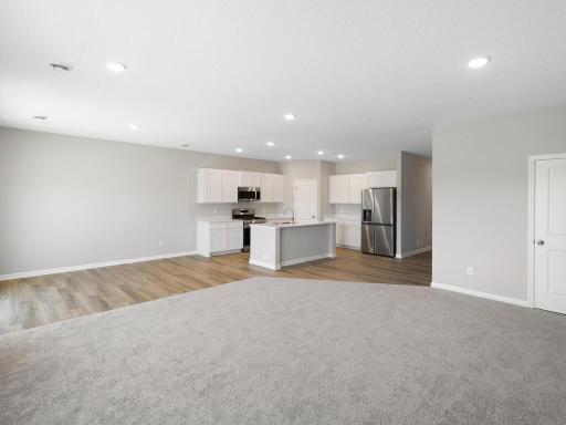 Living Room. Photo taken of another home with similar plan and finishes. Photos and renderings may not depict actual plan, materials, & finishes may vary. All measurements are approximate.