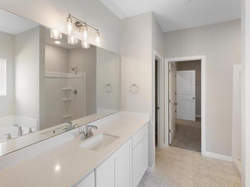 Primary Bathroom. Photo taken of another home with similar plan and finishes. Photos and renderings may not depict actual plan, materials, & finishes may vary. All measurements are approximate.