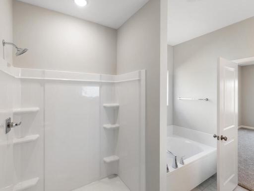 Primary Bathroom. Photo taken of another home with similar plan and finishes. Photos and renderings may not depict actual plan, materials, & finishes may vary. All measurements are approximate.