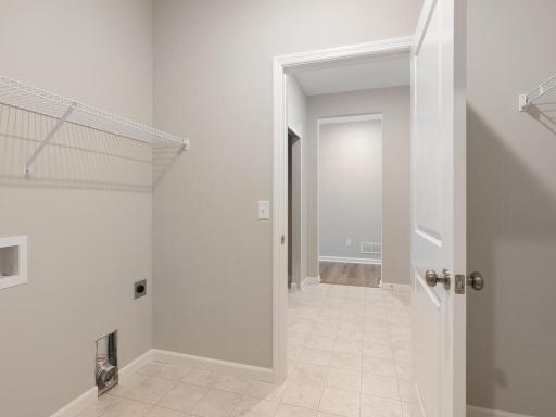 Laundry Room. Photo taken of another home with similar plan and finishes. Photos and renderings may not depict actual plan, materials, & finishes may vary. All measurements are approximate.
