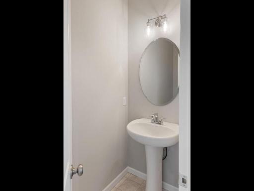 Powder Bathroom. Photo taken of another home with similar plan and finishes. Photos and renderings may not depict actual plan, materials, & finishes may vary. All measurements are approximate.