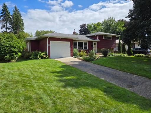 front with well-cared for lawn and beautiful landscaping