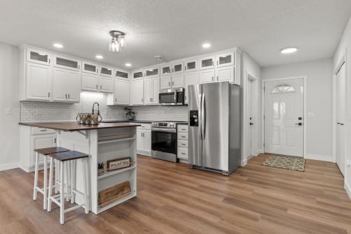 Welcome to your completed renovated home - new tile backsplash, sink, center island, updated cabinets and more!