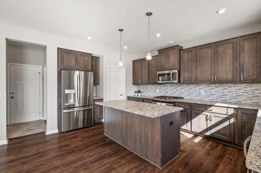 High-end cabinetry and bright, naturally lit open concept kitchen