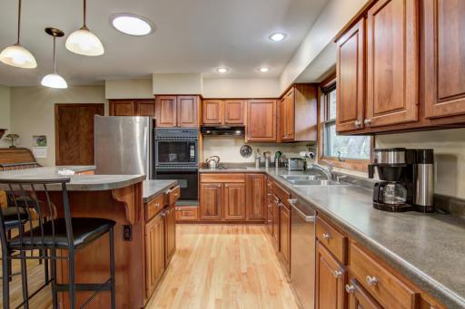Beautiful kitchen space w/refaced cherry cabinetry and gorgeous birch hardwood floors!
