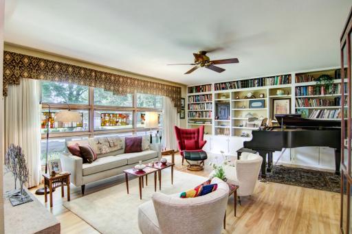 Elegant living room space w/beautiful birch hardwood floors and great book shelf storage!