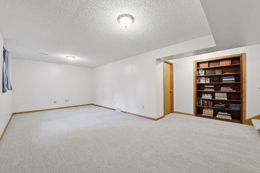 Lower level with built in shelving for books or items you use often. Storage room behind door for extra space.