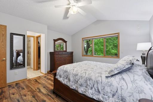 View into walk in closet, bathroom and tile surround shower in 2nd primary located in upper level.