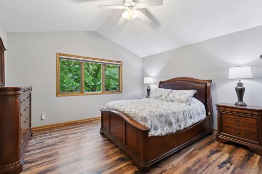 Upper level vaulted 2nd primary bedroom suite with new flooring.