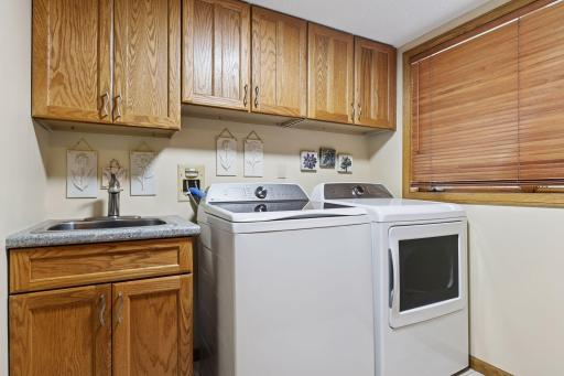 Main level laundry with tiled floors that connects to the 3/4th bath.