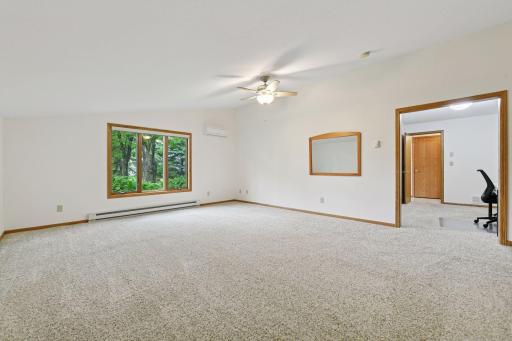 Main level primary bedroom is huge with additional AC wall unit. This also is a flex space if your seeking a bonus room on main. This space also has its own closet for storage or clothes besides the entry area where you walk into the room.