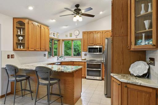 Buyers will love this updated kitchen with tile backsplash, granite counters and new SS appliances.