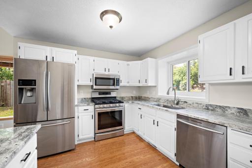 Stainless steel appliances, white cabinetry and granite countertops make this kitchen feel, not only functional, but timeless and bright!