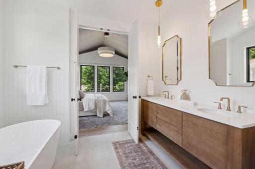 This primary suite is a true sanctuary, complete with private en suite equipped with heated floors, walk in serenity shower, soaker tub, and dual vanity.