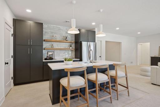 Entertain effortlessly with a sleek wet bar, open concept lounge and dining space, and direct access to the backyard.