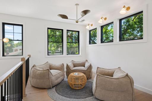 The natural light floods in, catching the angles of the custom railings and highlighting the soaring ceilings.