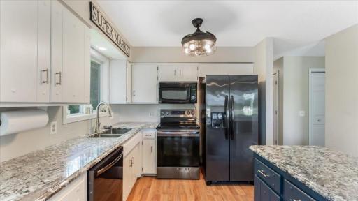 This clean and functional kitchen offers a warm and inviting atmosphere with plenty of cabinet space, and durable countertops.