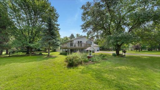 Step outside onto the deck and take in the peaceful views of the spacious yard and mature trees, perfect for morning coffee or evening gatherings.